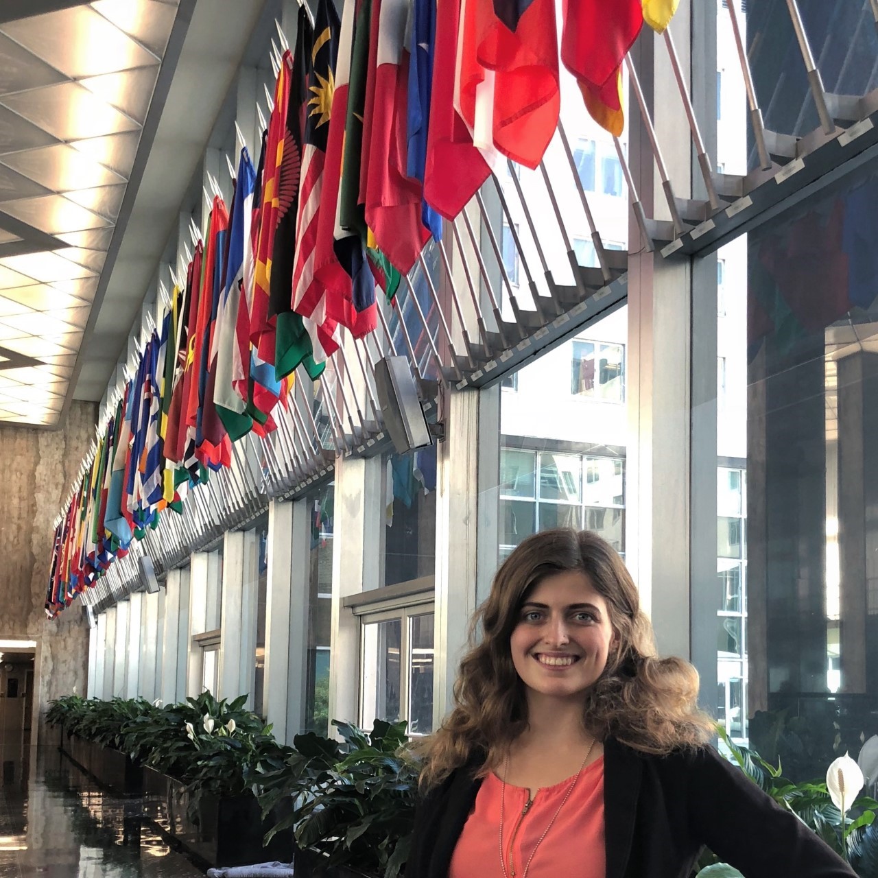 Natalie Hix in front of flags